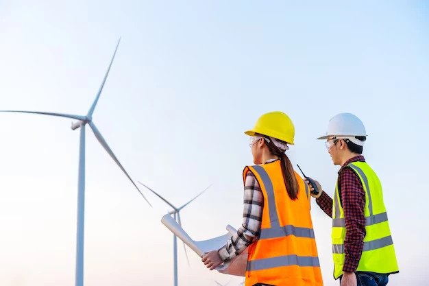 young-engineer-team-analyze-blueprint-drawing-wind-turbine-farm_35076-4803